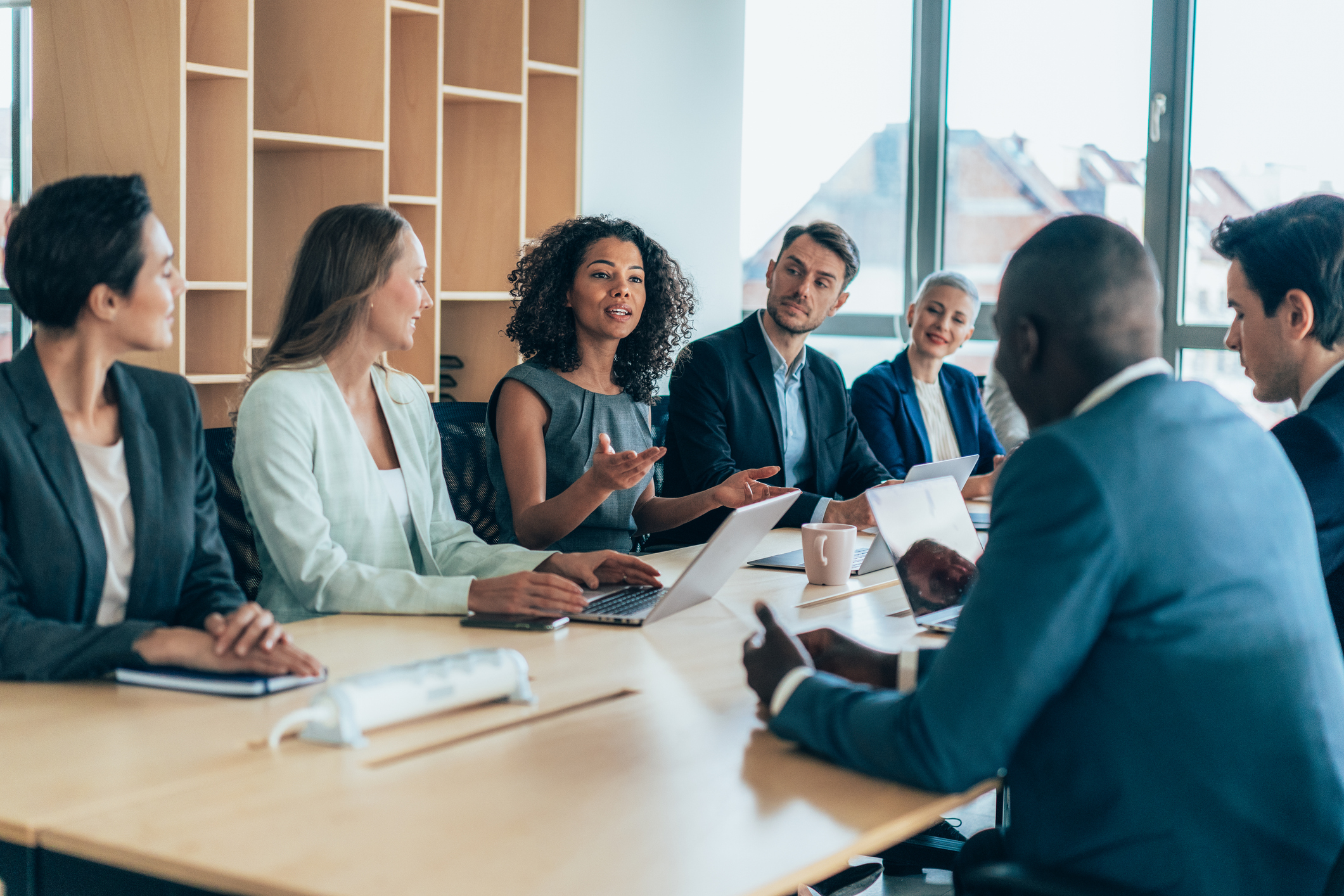 Multiethnic  group of businesspeople sitting together and having a meeting in the office.